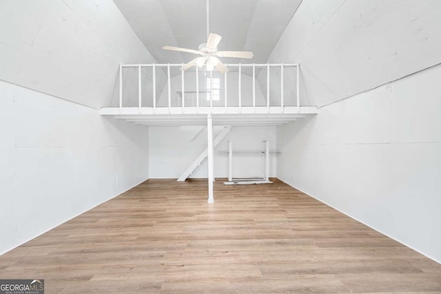 unfurnished living room featuring ceiling fan, lofted ceiling, and light wood-type flooring