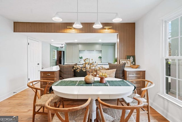 dining area featuring breakfast area and light wood-type flooring