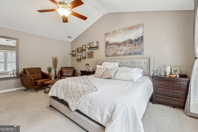 carpeted bedroom with ceiling fan and vaulted ceiling