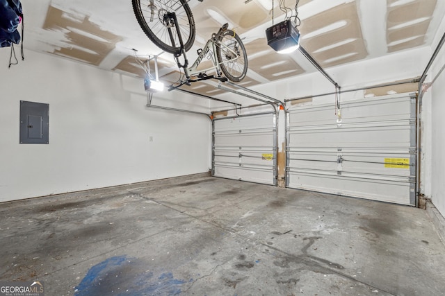 garage with a garage door opener and electric panel