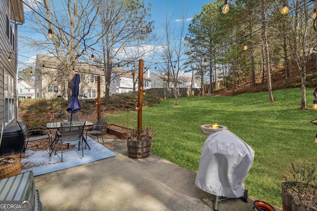 view of yard featuring a patio and a fire pit