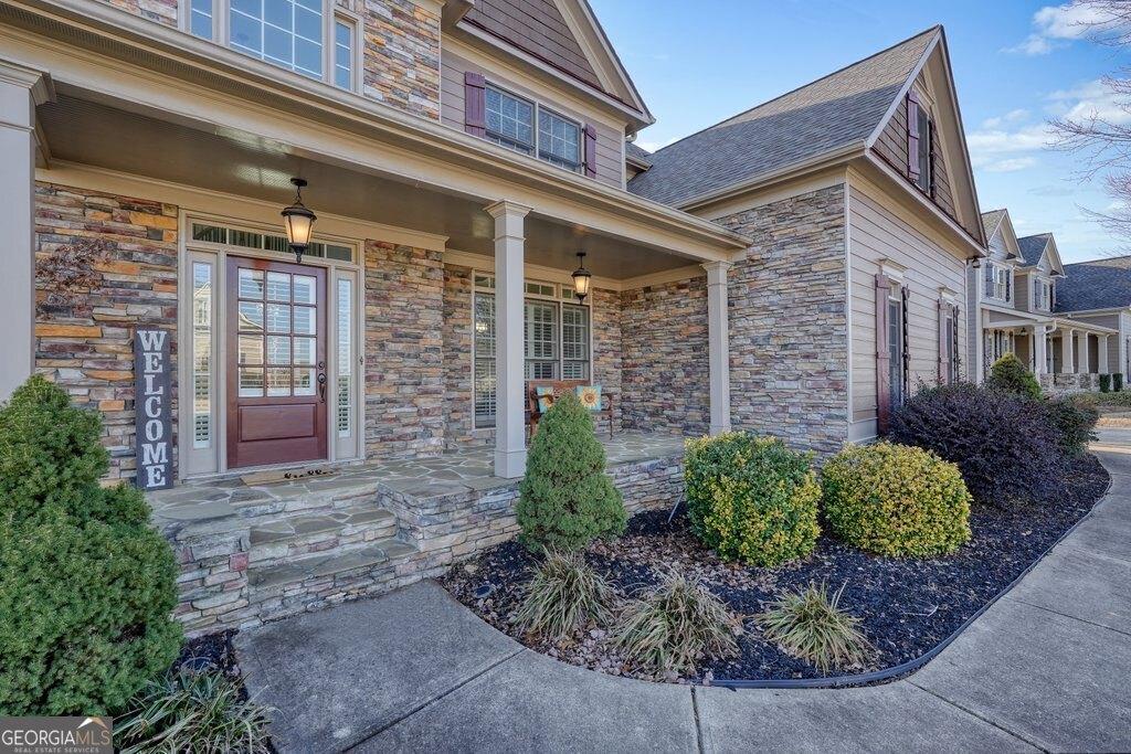 view of exterior entry featuring covered porch