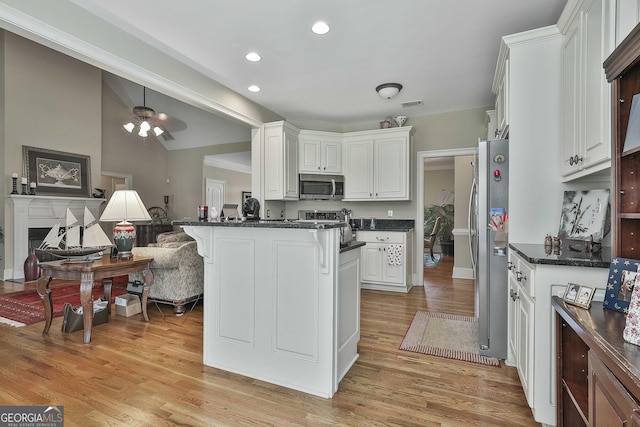 kitchen with white cabinetry, light hardwood / wood-style flooring, stainless steel appliances, and kitchen peninsula