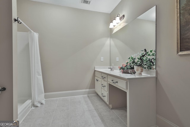 bathroom with shower / tub combo with curtain, vanity, and tile patterned flooring