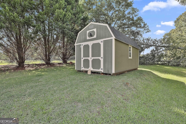 view of outbuilding featuring a yard