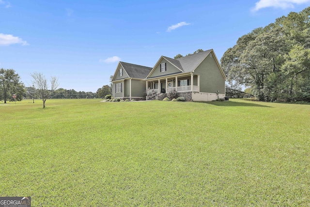 view of front of house featuring covered porch and a front lawn