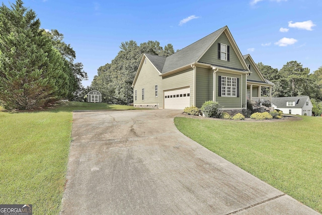 view of front of home with a storage shed, a garage, and a front yard