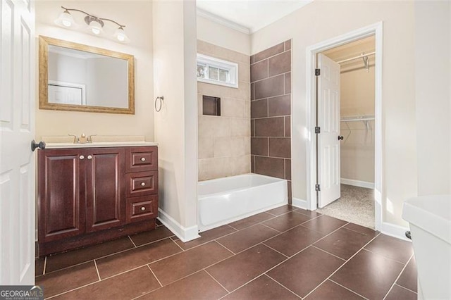 bathroom featuring vanity, tiled shower / bath combo, and tile patterned flooring