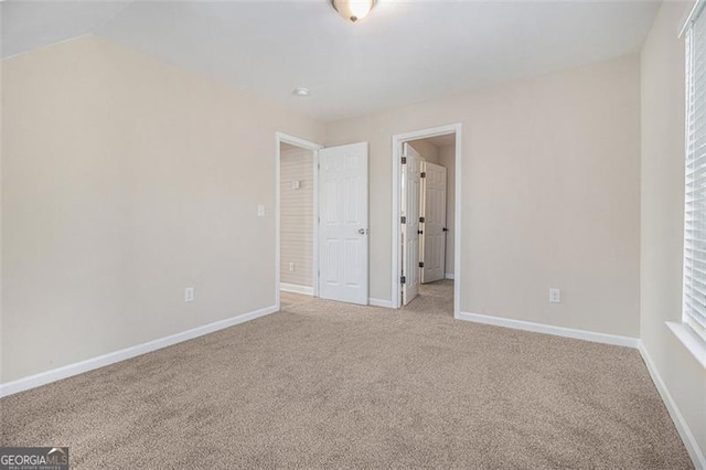 empty room featuring light carpet