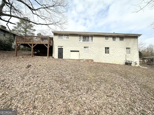 back of house featuring a wooden deck