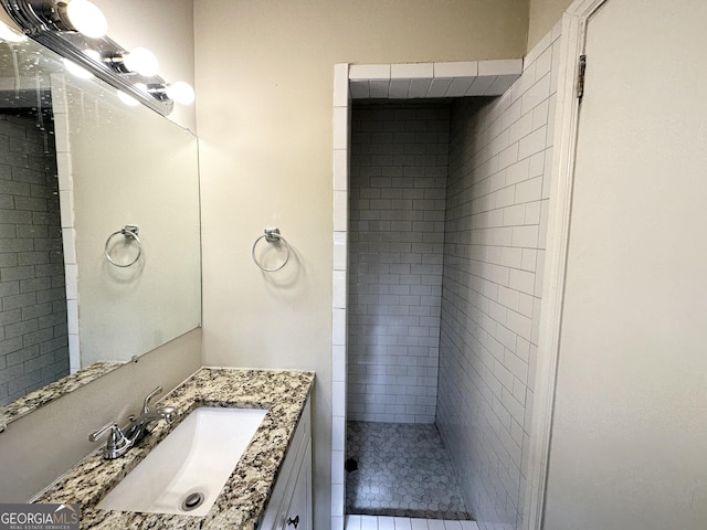 bathroom featuring vanity and a tile shower