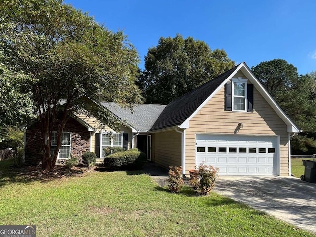 view of front of home featuring a garage and a front lawn