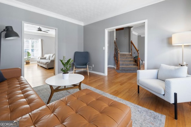 living room with crown molding and wood-type flooring