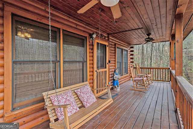 wooden deck featuring a ceiling fan and a porch