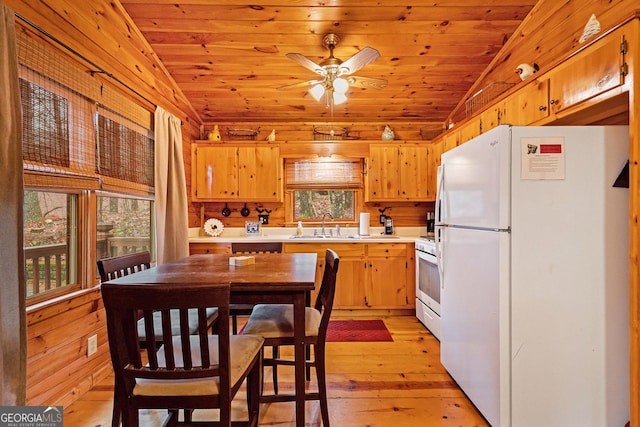 kitchen with white appliances, wood ceiling, vaulted ceiling, and light countertops