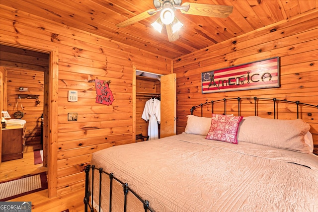 bedroom featuring wood walls, wood ceiling, and a ceiling fan