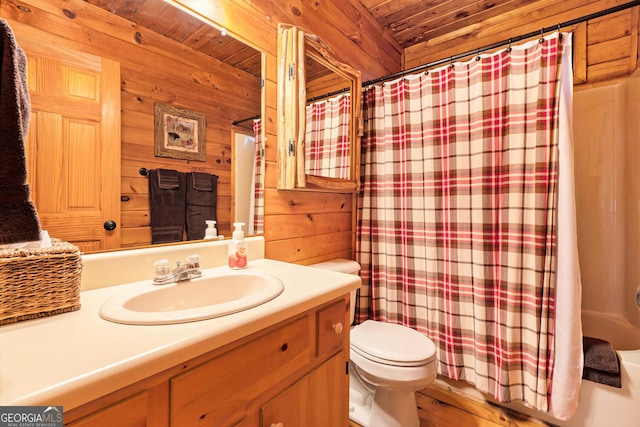 bathroom with wooden ceiling, vanity, toilet, and wooden walls