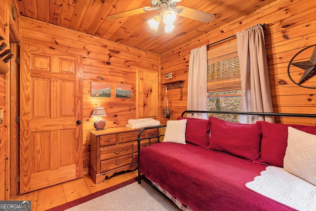 bedroom with wood walls, wooden ceiling, and hardwood / wood-style flooring