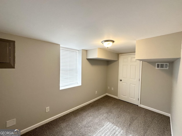 basement featuring carpet floors and electric panel