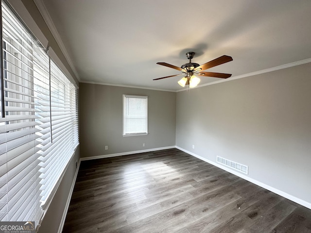 empty room with dark hardwood / wood-style flooring, crown molding, and ceiling fan