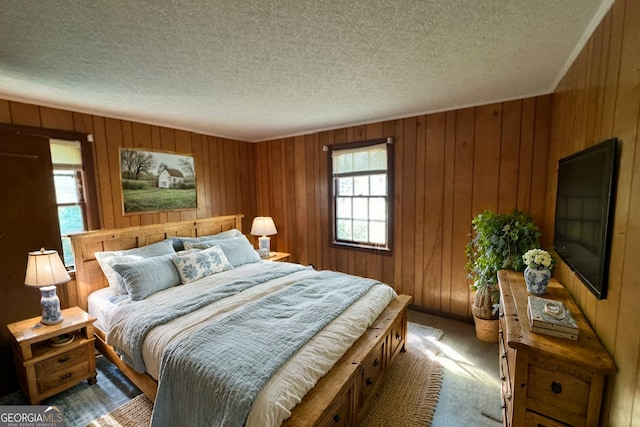 bedroom with carpet floors and a textured ceiling