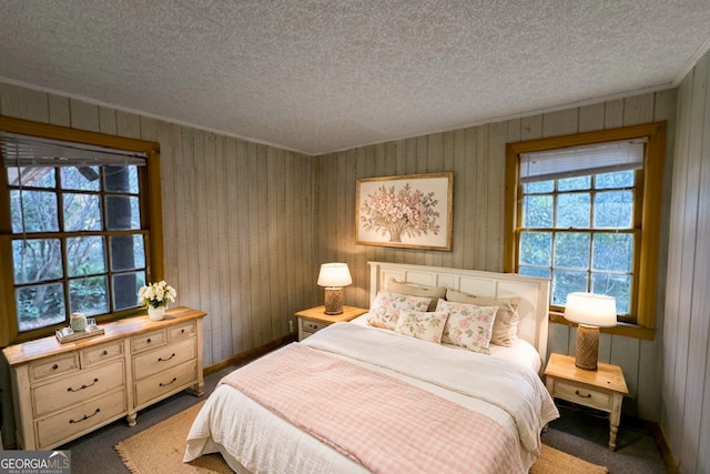 bedroom featuring carpet flooring and a textured ceiling