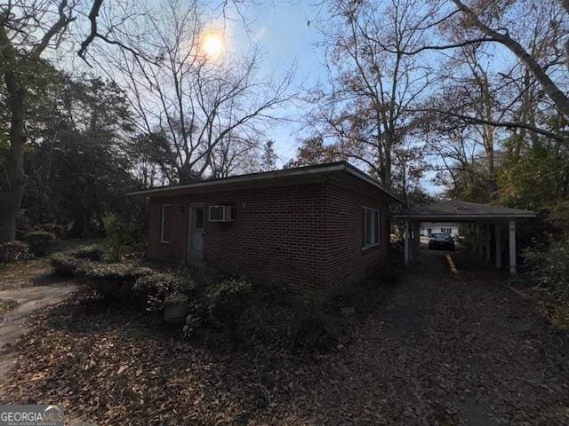 view of side of property featuring a carport