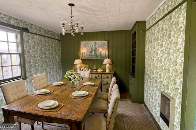 dining room featuring a chandelier and heating unit