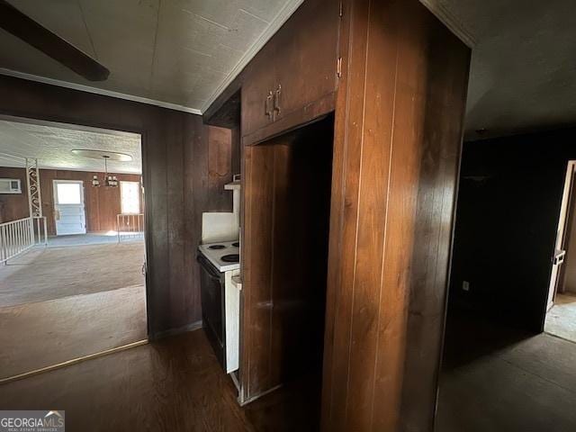 kitchen with electric range oven, crown molding, and wood-type flooring