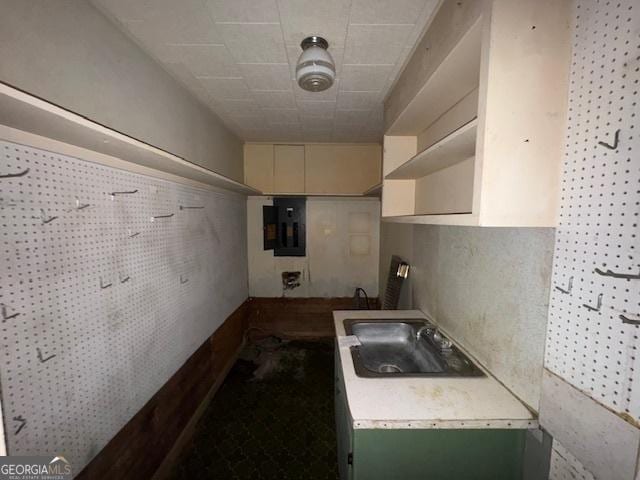 kitchen featuring electric panel and sink