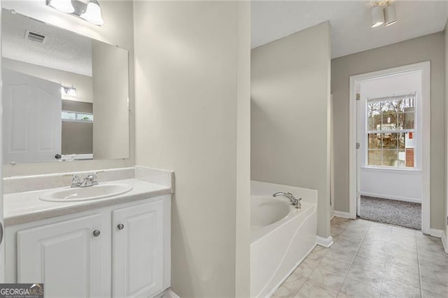 bathroom featuring vanity and a tub