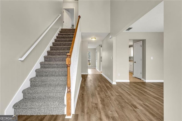 staircase featuring wood-type flooring