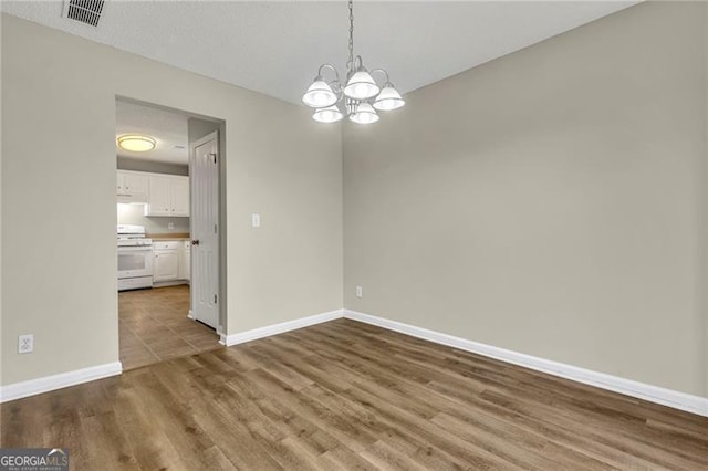 interior space with wood-type flooring and an inviting chandelier