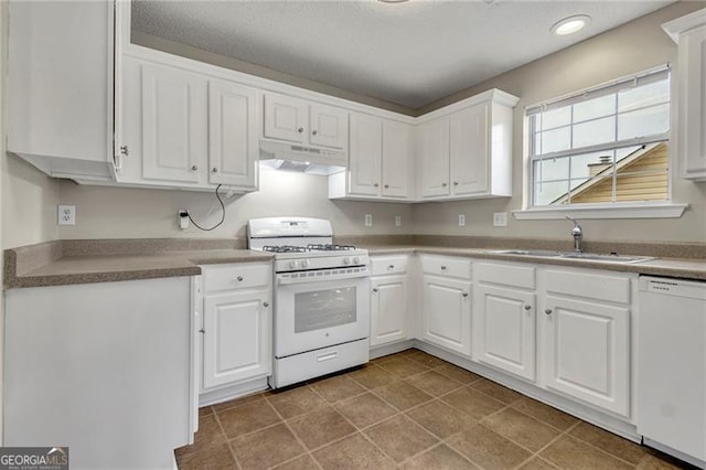 kitchen featuring white cabinetry, white appliances, tile patterned floors, and sink