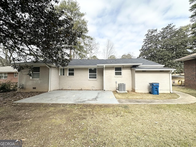 rear view of house featuring central AC, a yard, and a patio area