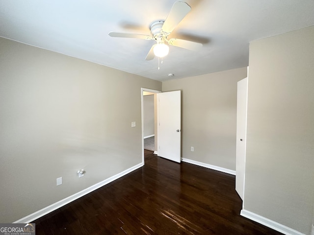 spare room with ceiling fan and dark hardwood / wood-style flooring