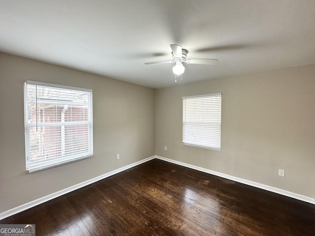 unfurnished room featuring dark hardwood / wood-style floors and ceiling fan