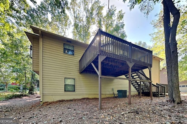 back of property with central AC and a deck