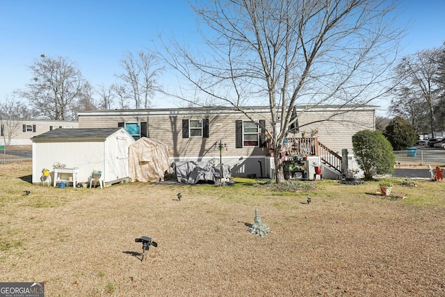 back of property featuring a yard and a shed