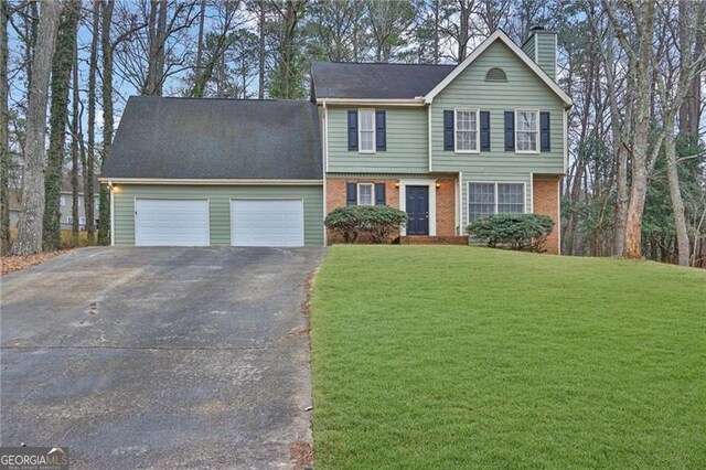 view of front of house with a garage and a front lawn