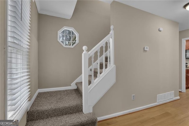 stairway featuring wood-type flooring