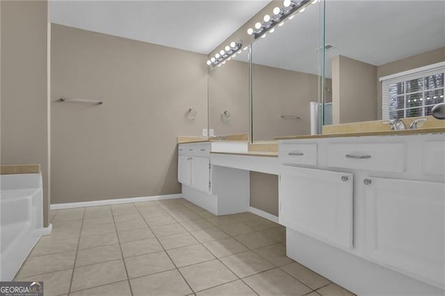 bathroom with tile patterned flooring, vanity, and a bathtub