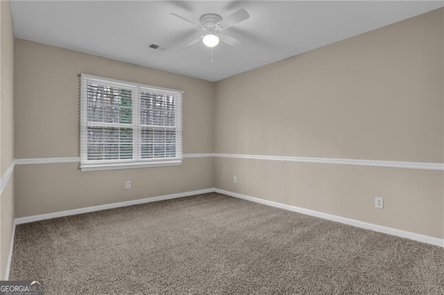 carpeted empty room featuring ceiling fan