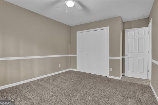 unfurnished bedroom with carpet floors, ceiling fan, and a closet