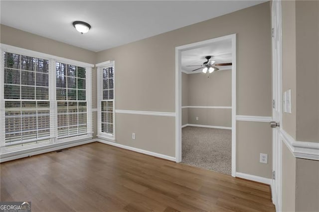 spare room with ceiling fan and wood-type flooring