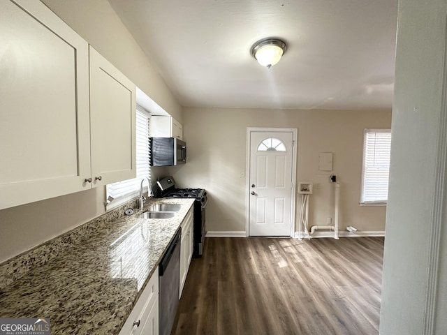 kitchen with white cabinetry, appliances with stainless steel finishes, and light stone countertops