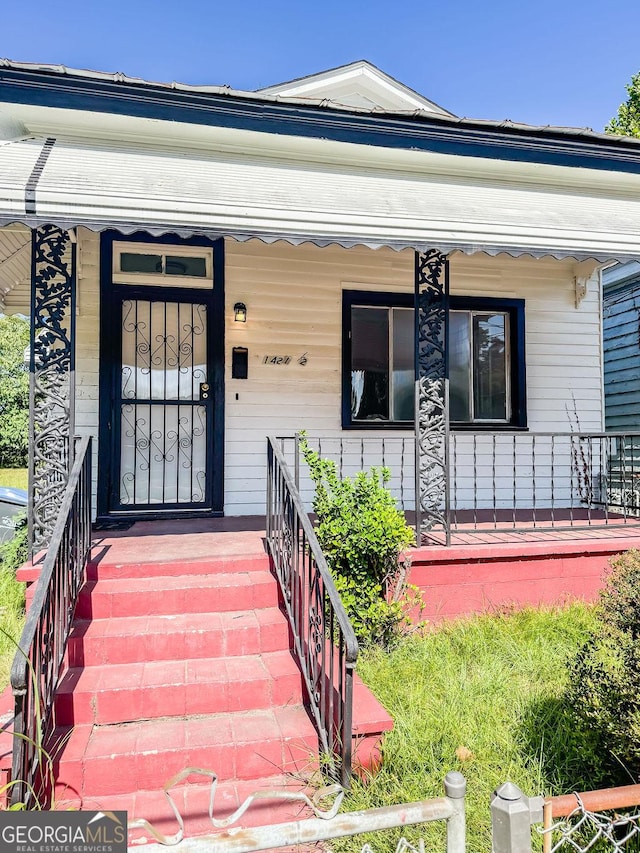 view of exterior entry featuring a porch