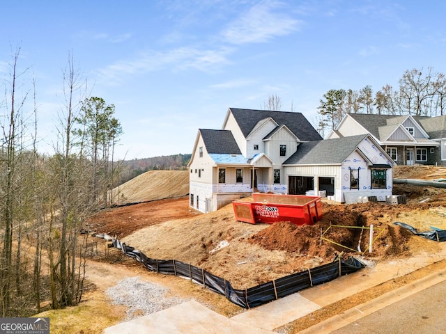 view of front of home with cooling unit, board and batten siding, a shingled roof, and fence