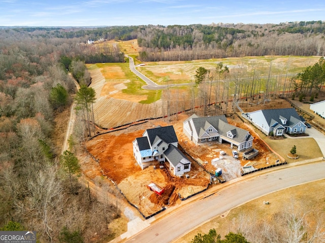 birds eye view of property featuring a wooded view