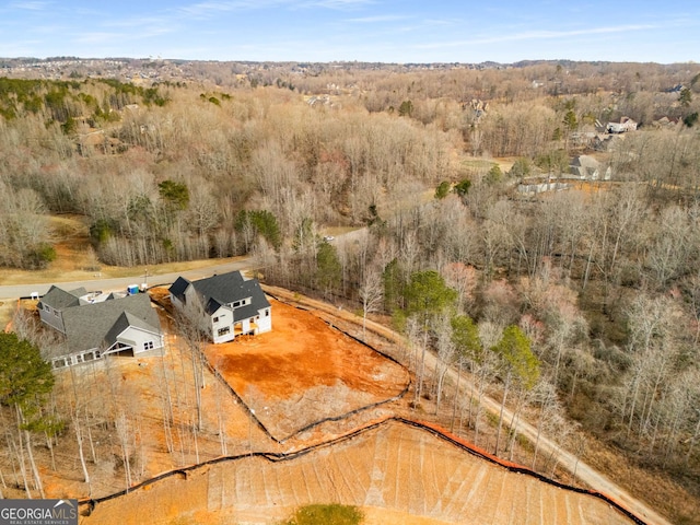 birds eye view of property with a wooded view